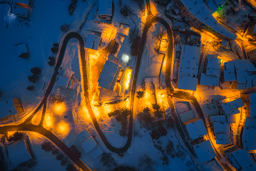Aerial view of the snow covered town of Rivisondoli illuminated at night in Rivisondoli Abruzzo Italy.