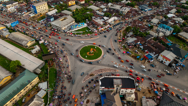 Aerial view of a busy roundabout with heavy traffic cars and motorcycles in the urban center of Uyo Akwa Ibom Nigeria. Aerial view of a busy roundabout with heavy traffic cars and motorcycles in the urban center of Uyo Akwa Ibom Nigeria.