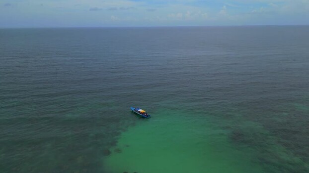 Aerial view of small boat off Batam Island Indonesia. Aerial view of small boat off Batam Island Indonesia.