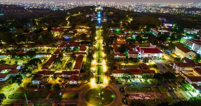 Aerial view of the University of Ghana campus at night with illuminated buildings a central landscaped axis and the sprawling city skyline in the background Ghana. Aerial view of the University of Ghana campus at night with illuminated buildings a central landscaped axis and the sprawling city skyline in the background Ghana.