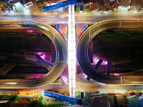 Aerial view of illuminated Flyover Tapal Kuda Jakarta at night with vibrant traffic light trails through the horseshoe shaped structure in Pasar Minggu Daerah Khusus Ibukota Indonesia. Aerial view of illuminated Flyover Tapal Kuda Jakarta at night with vibrant traffic light trails through the horseshoe shaped structure in Pasar Minggu Daerah Khusus Ibukota Indonesia.