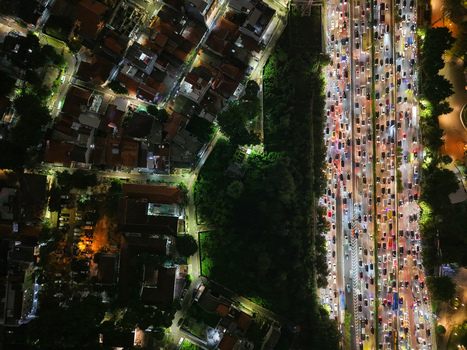 Aerial view of the Semanggi interchange at night showing heavy traffic congestion on the highway surrounded by urban buildings and trees in Setiabudi Jakarta Indonesia. Aerial view of the Semanggi interchange at night showing heavy traffic congestion on the highway surrounded by urban buildings and trees in Setiabudi Jakarta Indonesia.