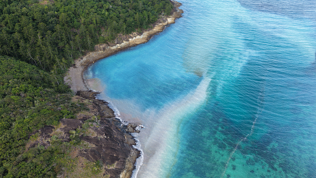 Aerial view of Chance Bay with its turquoise waters sandy beach and lush green forest in Whitsundays Queensland Australia. Aerial view of Chance Bay with its turquoise waters sandy beach and lush green forest in Whitsundays Queensland Australia.