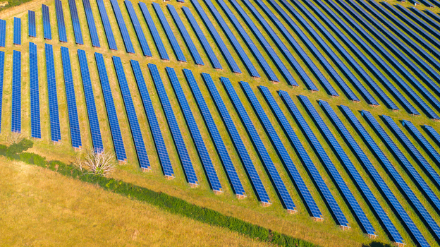 Aerial view of rows of solar panels in a field in Dorset England United Kingdom.