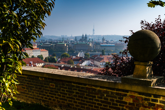 View of the historic skyline featuring the Zizkov Television Tower red tiled rooftops and stone walls in the foreground Prague Prague Czechia.
