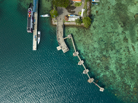 Aerial view of turquoise waters meet the weathered docks of Karimunjawa ferry harbour a vibrant contrast to the lush greenery Karimunjawa Jawa Tengah Indonesia. Aerial view of turquoise waters meet the weathered docks of Karimunjawa ferry harbour a vibrant contrast to the lush greenery Karimunjawa Jawa Tengah Indonesia.