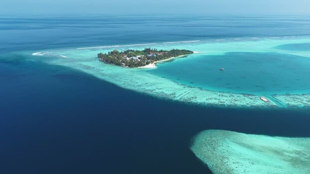 Aerial view of a tropical island and coral reefs Maldives. Aerial view of a tropical island and coral reefs Maldives.