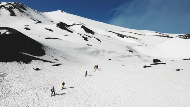 Aerial view of hikers on the snowy slopes of Mount Etna Italy. Aerial view of hikers on the snowy slopes of Mount Etna Italy.