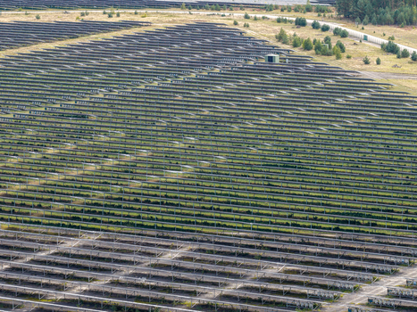 Aerial view of the solar field at the former military airfield in Preschen with rows of solar panels over the historic runway and taxiway in Neisse Malxetal Brandenburg Germany. Aerial view of the solar field at the former military airfield in Preschen with rows of solar panels over the historic runway and taxiway in Neisse Malxetal Brandenburg Germany.