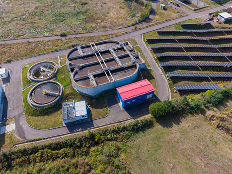 Aerial view of a sewage treatment plant featuring circular sedimentation tanks and a solar panel field in Targu Secuiesc Covasna County Romania.