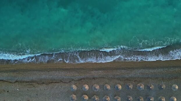 Aerial view of beach with parasols in Greece.