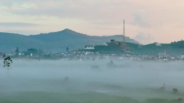 Aerial view of a misty village and hills in Pekalongan Indonesia. Aerial view of a misty village and hills in Pekalongan Indonesia.
