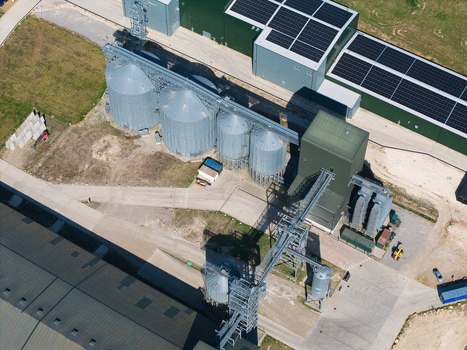 Aerial view of the Oat Milling Factory featuring large silver grain silos industrial buildings with solar panels and complex conveyor systems Kettering England United Kingdom. Aerial view of the Oat Milling Factory featuring large silver grain silos industrial buildings with solar panels and complex conveyor systems Kettering England United Kingdom.