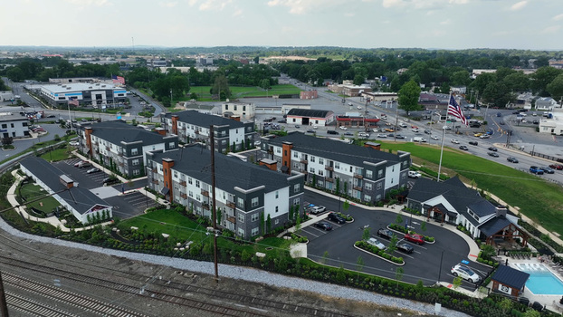 Aerial view of a modern residential apartment complex with landscaped grounds parking areas and a swimming pool in Lancaster Pennsylvania United States.