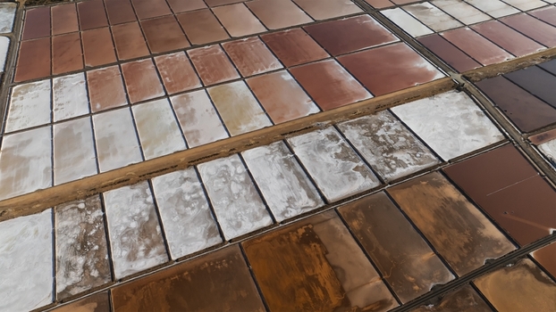 Aerial view of geometric salt evaporation ponds with varying shades of pink and brown in Cagliari Sardinia Italy. Aerial view of geometric salt evaporation ponds with varying shades of pink and brown in Cagliari Sardinia Italy.
