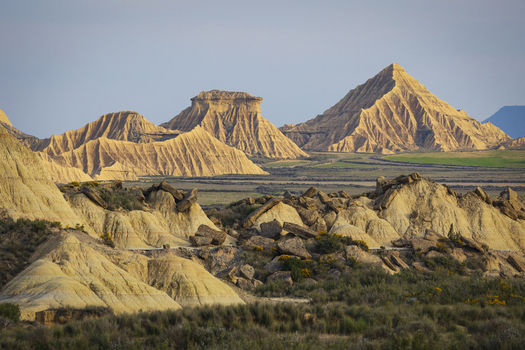 View of the unique eroded rock formations and arid badlands of Bardenas Reales under a clear sky in Navarre Spain. View of the unique eroded rock formations and arid badlands of Bardenas Reales under a clear sky in Navarre Spain.