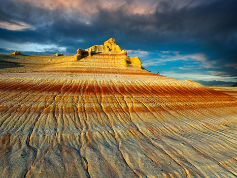 Aerial view of Aktau mountains with layered sandstone formations under a dramatic sky showcasing nature s artistry Aktau Kazakhstan.