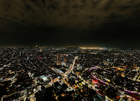 Aerial view of the illuminated cityscape of Surabaya at night featuring dense urban grids glowing skyscrapers and vibrant street lights in Surabaya East Java Indonesia. Aerial view of the illuminated cityscape of Surabaya at night featuring dense urban grids glowing skyscrapers and vibrant street lights in Surabaya East Java Indonesia.