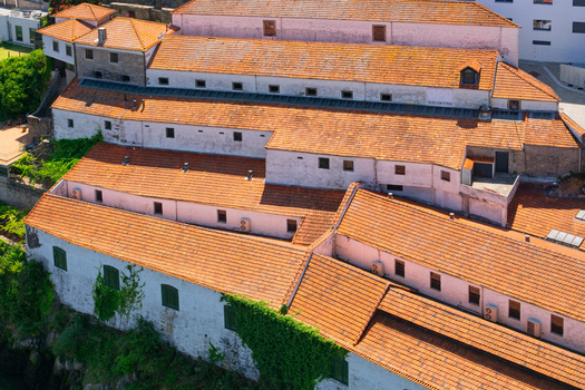 Aerial view of the old buildings with terracotta roofs and green vines a blend of urban architecture and natural beauty Porto Porto District Portugal. Aerial view of the old buildings with terracotta roofs and green vines a blend of urban architecture and natural beauty Porto Porto District Portugal.