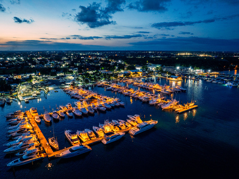 Aerial view of Club Nautico de Santo Domingo Inc. with numerous yachts and boats moored at the marina illuminated at twilight in Andres Santo Domingo Dominican Republic. Aerial view of Club Nautico de Santo Domingo Inc. with numerous yachts and boats moored at the marina illuminated at twilight in Andres Santo Domingo Dominican Republic.
