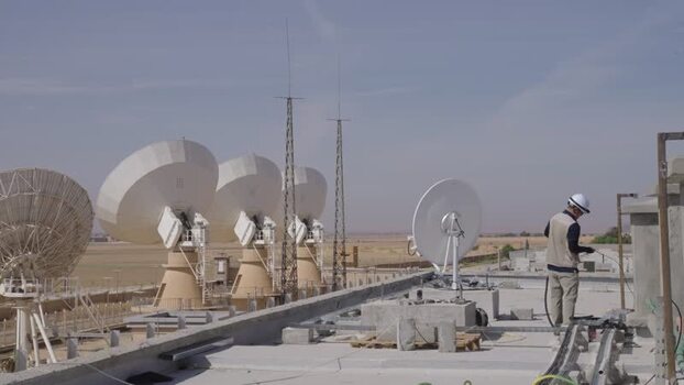 Aerial view of satellite dishes on a rooftop in Algeria.