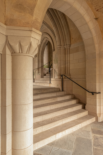 Washington United States 06 May 2025 View of the stone archway and stairs inside the Washington National Cathedral featuring Gothic architectural details and metal handrails.