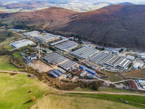 Aerial view of industrial buildings nestled amidst rolling hills and forests a contrast of man made structures and natural landscapes Detva Banskobystricky kraj Slovakia. Aerial view of industrial buildings nestled amidst rolling hills and forests a contrast of man made structures and natural landscapes Detva Banskobystricky kraj Slovakia.
