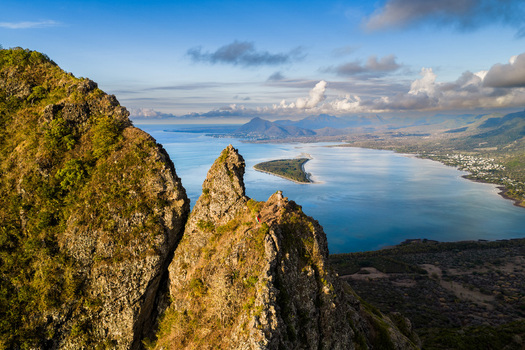 Aerial view of the sharp rocky mountain ridges overlooking the turquoise lagoon and coastal landscape Mauritius Moka District Mauritius. Aerial view of the sharp rocky mountain ridges overlooking the turquoise lagoon and coastal landscape Mauritius Moka District Mauritius.