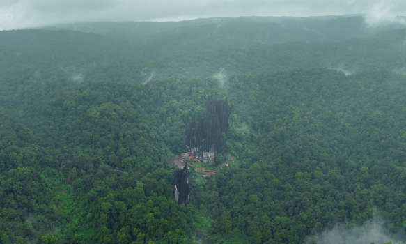 Aerial view of Yana Caves rising from the dense misty green forests of the Western Ghats in Yana Karnataka India.