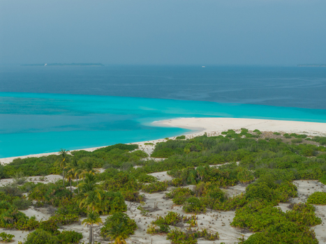 Aerial view of a pristine white sandbank with vibrant turquoise waters meeting deep blue ocean and lush green vegetation Hoarafushi Thiladhunmathee Uthuruburi Maldives. Aerial view of a pristine white sandbank with vibrant turquoise waters meeting deep blue ocean and lush green vegetation Hoarafushi Thiladhunmathee Uthuruburi Maldives.