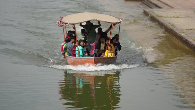 View of people on a boat in the Lumbini canal Nepal.