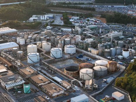 Aerial view of a plant for the production of finished lubricants featuring numerous storage tanks industrial buildings and pipelines in Vado Ligure Liguria Italy. Aerial view of a plant for the production of finished lubricants featuring numerous storage tanks industrial buildings and pipelines in Vado Ligure Liguria Italy.