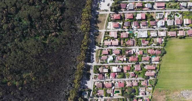 Aerial view of a residential area next to a dense forest Italy.