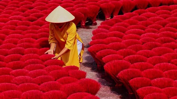 View of a person among red incense sticks in Quang Phu Cau Vietnam.