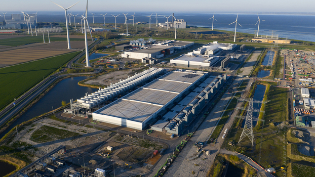 Drone view of a hyperscale data center in Eemshaven showing cloud computing server infrastructure cooling systems backup power and digital connectivity. Drone view of a hyperscale data center in Eemshaven showing cloud computing server infrastructure cooling systems backup power and digital connectivity.