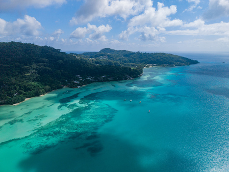 Aerial view of azure waters meet lush green hillsides creating a breathtaking contrast in this tropical paradise Victoria Mahe Island Seychelles. Aerial view of azure waters meet lush green hillsides creating a breathtaking contrast in this tropical paradise Victoria Mahe Island Seychelles.