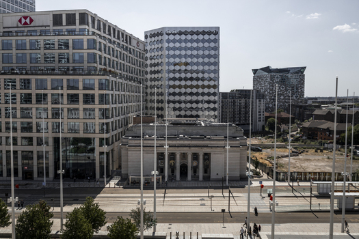 Aerial view of the Birmingham Museum and Art Gallery surrounded by modern office buildings and the city tram tracks in Birmingham England United Kingdom.