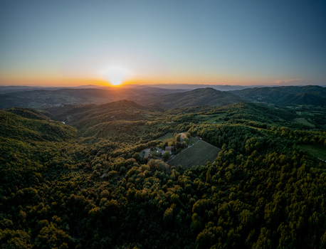 Aerial view of the rolling hills and dense forests of the Chianti region at sunset in Greve in Chianti Tuscany Italy.