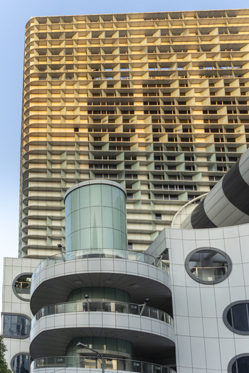 View of modern architecture featuring a grid patterned skyscraper and a white building with circular windows and glass balconies in Taipei City Taiwan. View of modern architecture featuring a grid patterned skyscraper and a white building with circular windows and glass balconies in Taipei City Taiwan.