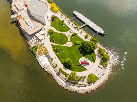 Aerial view of Danubiana Meulensteen Art Museum with green lawns sculptures and a docked barge on the Danube river in Bratislava Bratislavsky kraj Slovakia. Aerial view of Danubiana Meulensteen Art Museum with green lawns sculptures and a docked barge on the Danube river in Bratislava Bratislavsky kraj Slovakia.