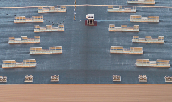 Aerial view of a modern industrial warehouse roof featuring rooftop HVAC equipment ventilation units and evenly spaced skylights in Alixan Auvergne Rhone Alpes France.
