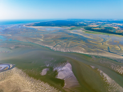 Aerial view of Baie de Somme showing the intricate tidal channels vast sandbanks and coastal landscape near Saint Valery sur Somme Hauts de France France. Aerial view of Baie de Somme showing the intricate tidal channels vast sandbanks and coastal landscape near Saint Valery sur Somme Hauts de France France.