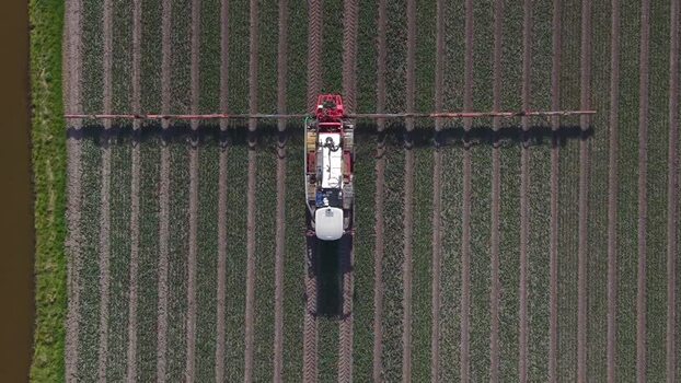Aerial view of farm vehicle in field Opmeer North Holland Netherlands. Aerial view of farm vehicle in field Opmeer North Holland Netherlands.