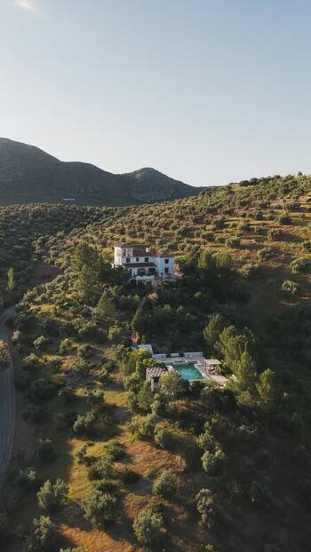 Aerial view of a villa with a pool on a hillside Spain.