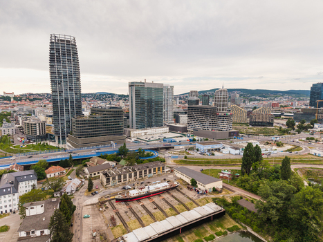 Aerial view of modern skyscrapers and urban skyline with a shipyard and boat on dry dock in the foreground Bratislava Bratislava Region Slovakia. Aerial view of modern skyscrapers and urban skyline with a shipyard and boat on dry dock in the foreground Bratislava Bratislava Region Slovakia.