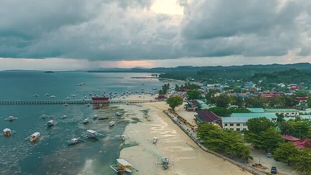Aerial view of tropical coastal town with boats in the Philippines.
