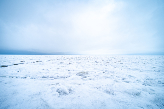 View of a vast frozen sea surface covered in ice and snow under a bright overcast sky in Sassnitz Mecklenburg Vorpommern Germany.