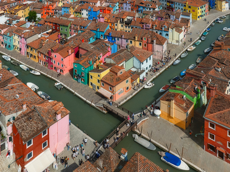 Aerial view of vibrant multicolored houses lining narrow canals a tapestry of vivid hues reflecting in the water Burano Veneto Italy. Aerial view of vibrant multicolored houses lining narrow canals a tapestry of vivid hues reflecting in the water Burano Veneto Italy.