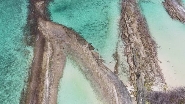 Aerial view of rocky formations and turquoise water Maldives.
