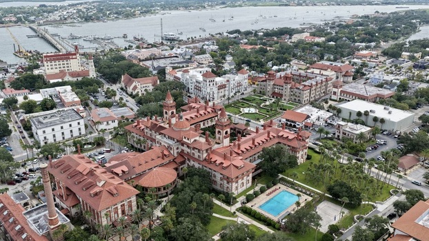 Aerial view of Flagler College featuring Spanish Renaissance Revival architecture red tiled roofs and lush courtyards in the historic city of St. Augustine Florida United States. Aerial view of Flagler College featuring Spanish Renaissance Revival architecture red tiled roofs and lush courtyards in the historic city of St. Augustine Florida United States.